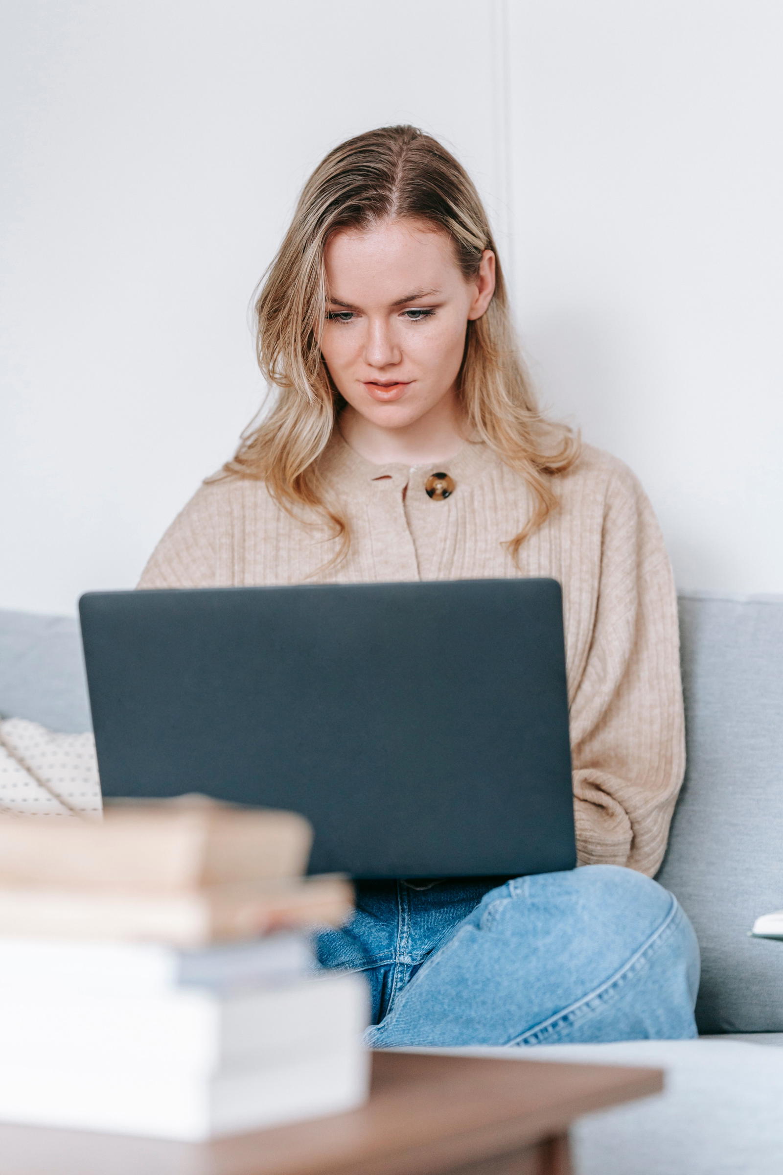 A person pausing at their laptop, thinking about what to say next during a timed speaking task