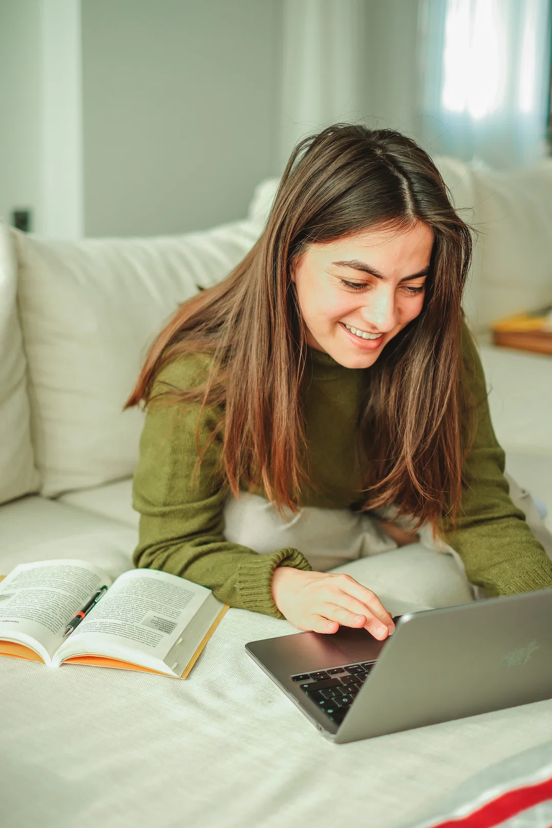 A student working at a laptop while preparing for the Duolingo English Test speaking section
