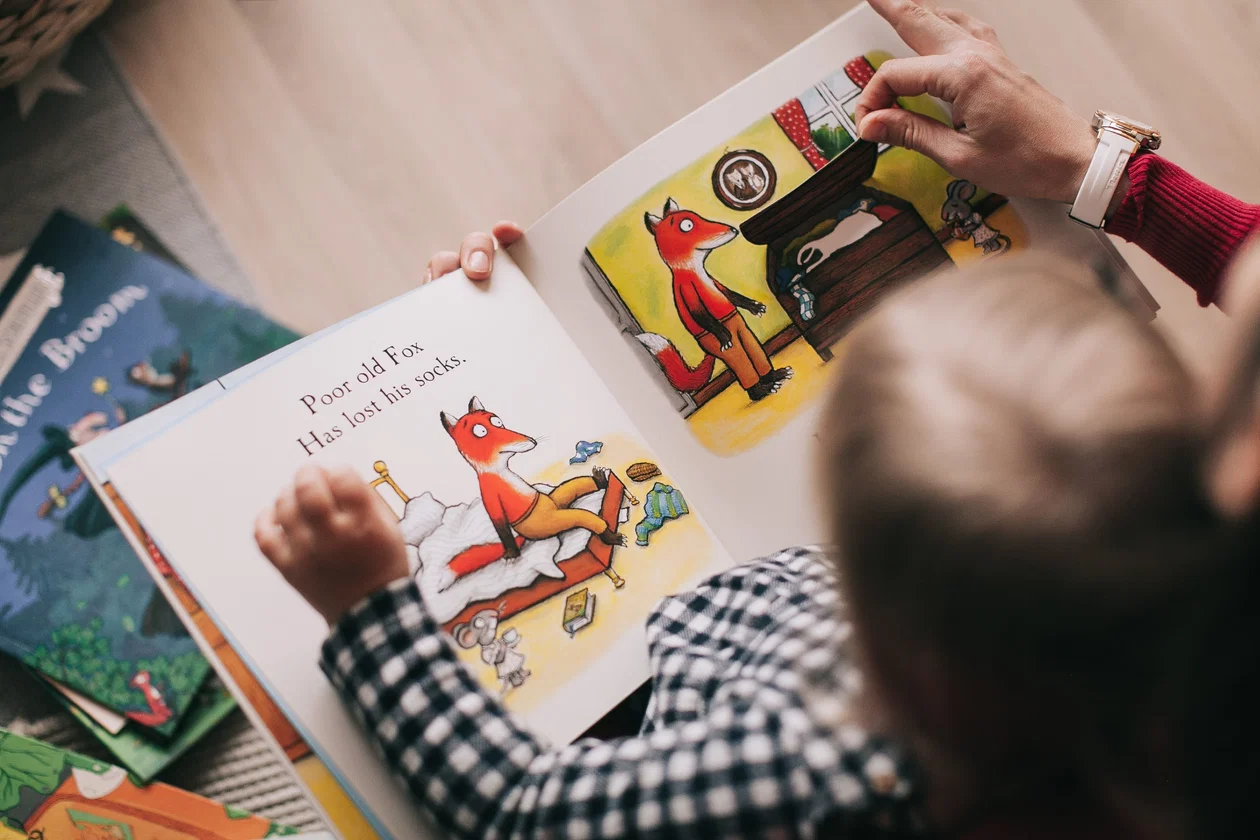 Parent and child reading together at home — English practice routine