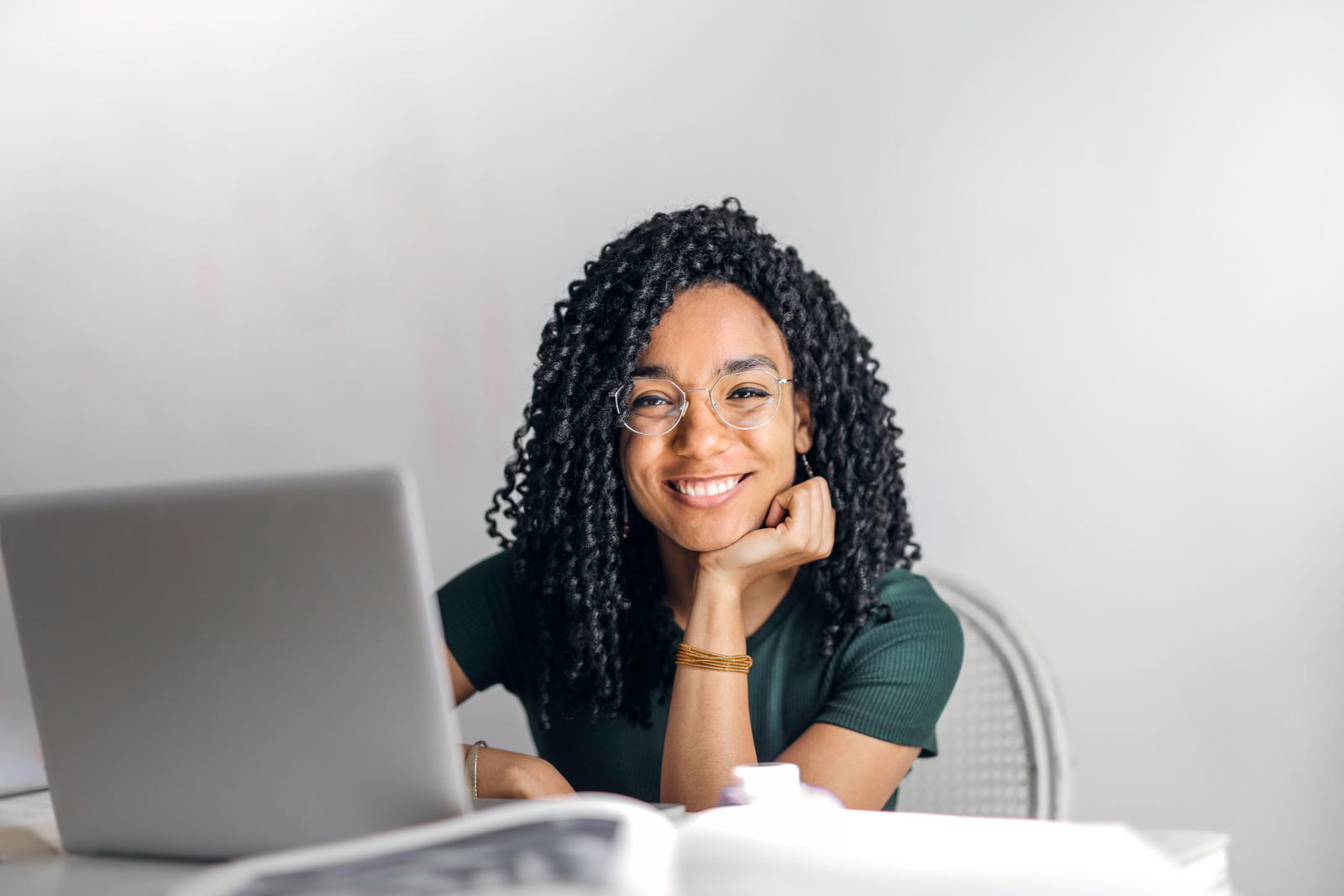 Stressed student studying alone at desk with books