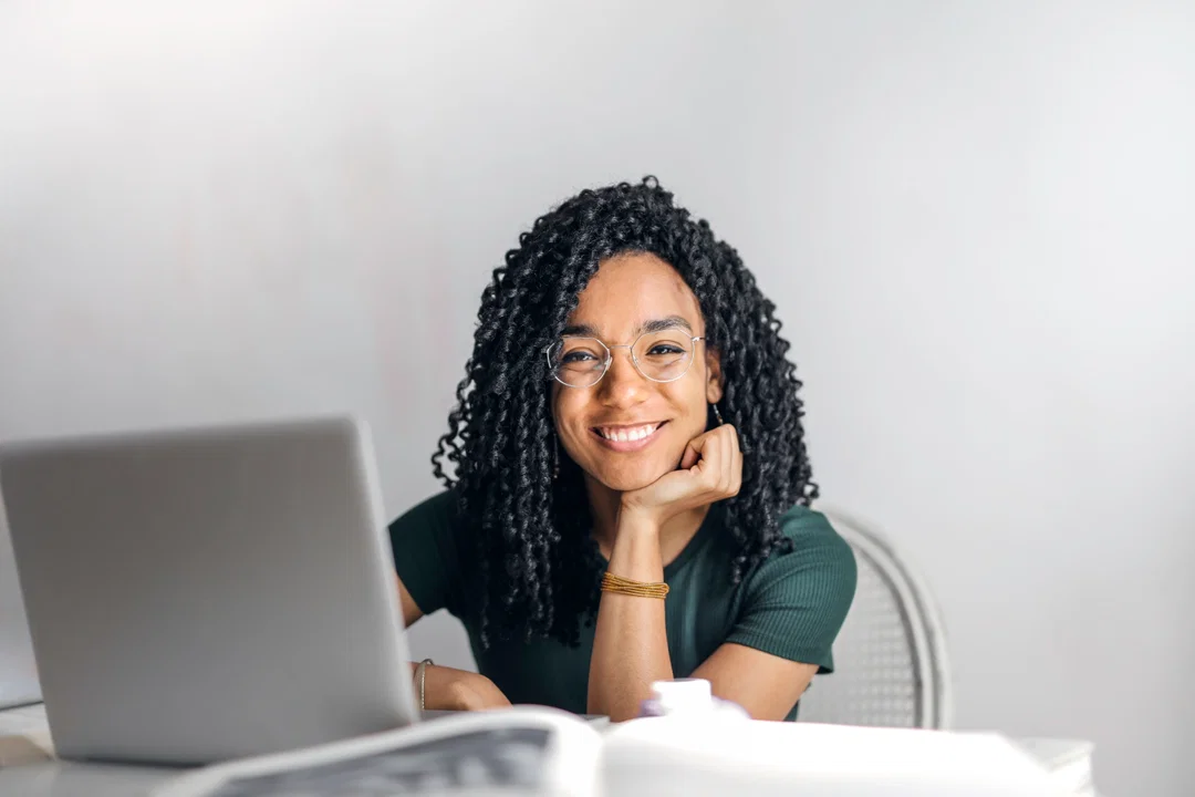 Stressed student studying alone at desk with books
