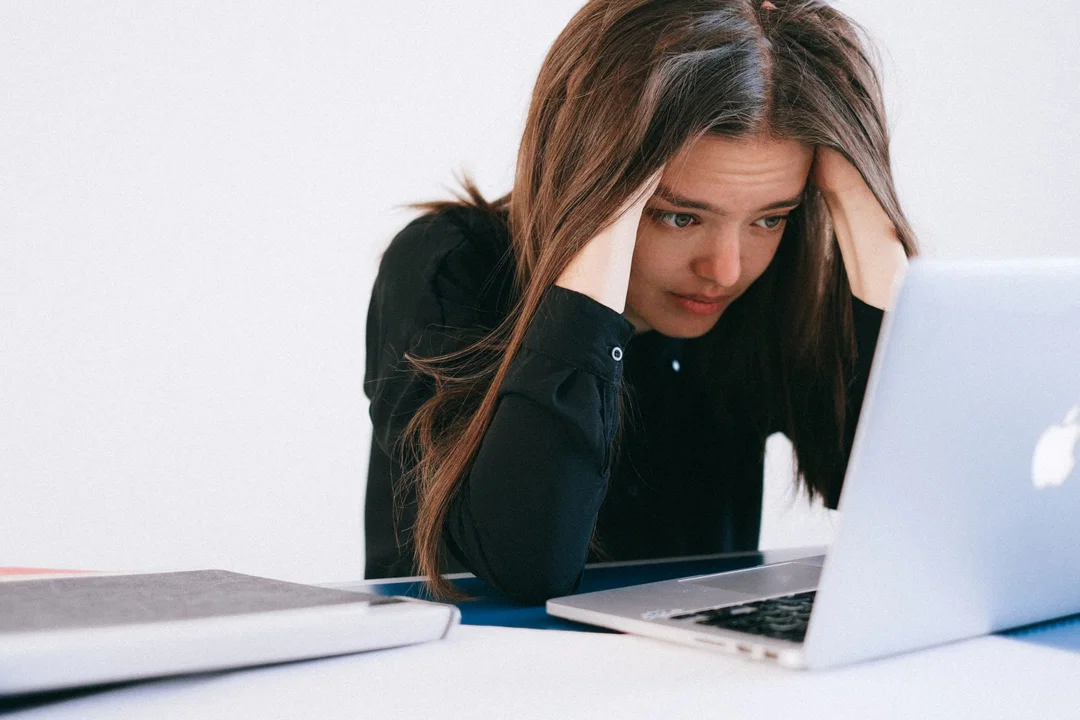 Student looking stressed at a laptop after receiving a Duolingo English Test writing score