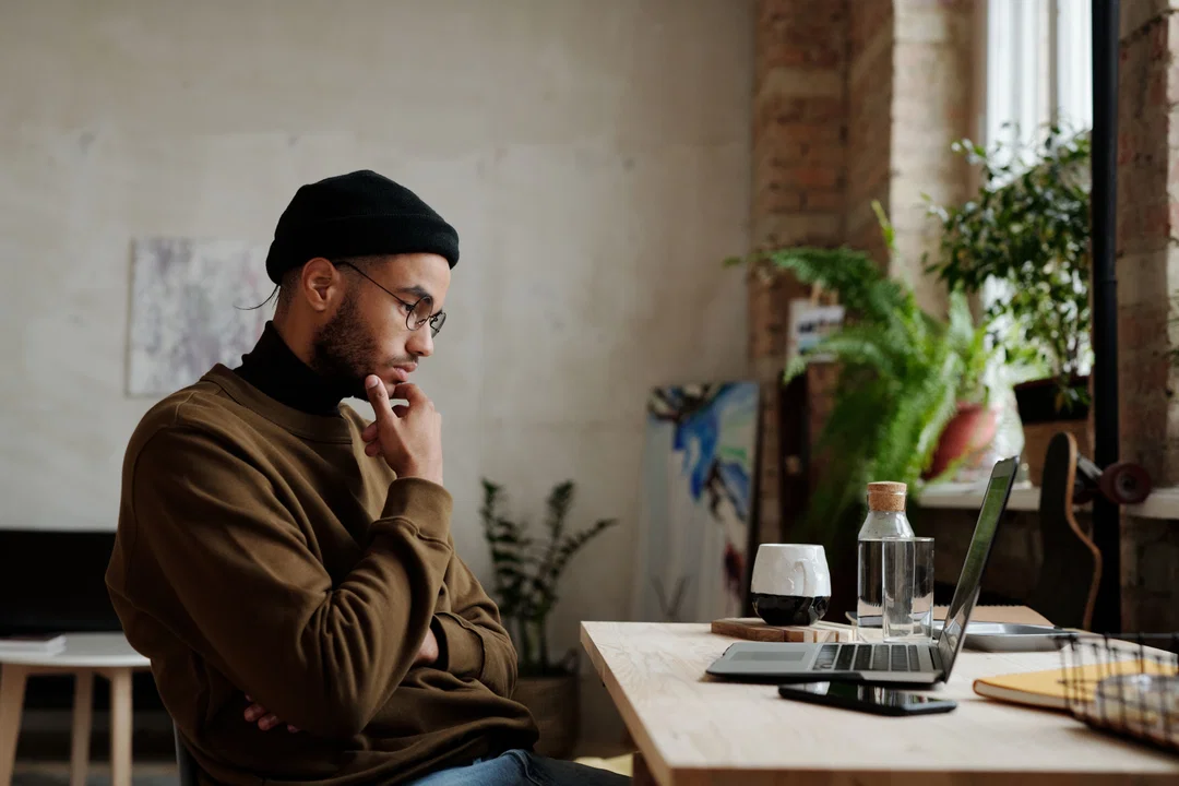 Man thinking while looking at laptop screen — wondering why DET score is not improving