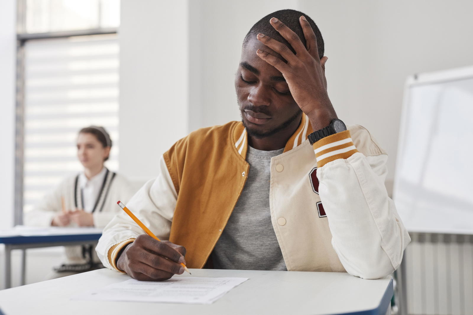 Man sitting at a table looking uncertain about his test results