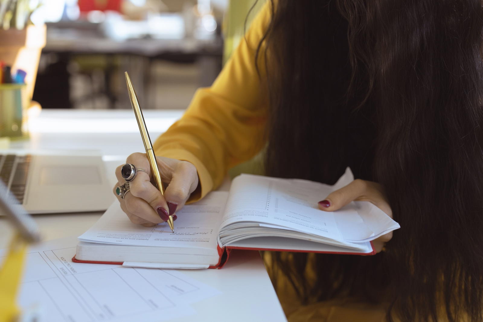 Woman writing in a notebook planning her response